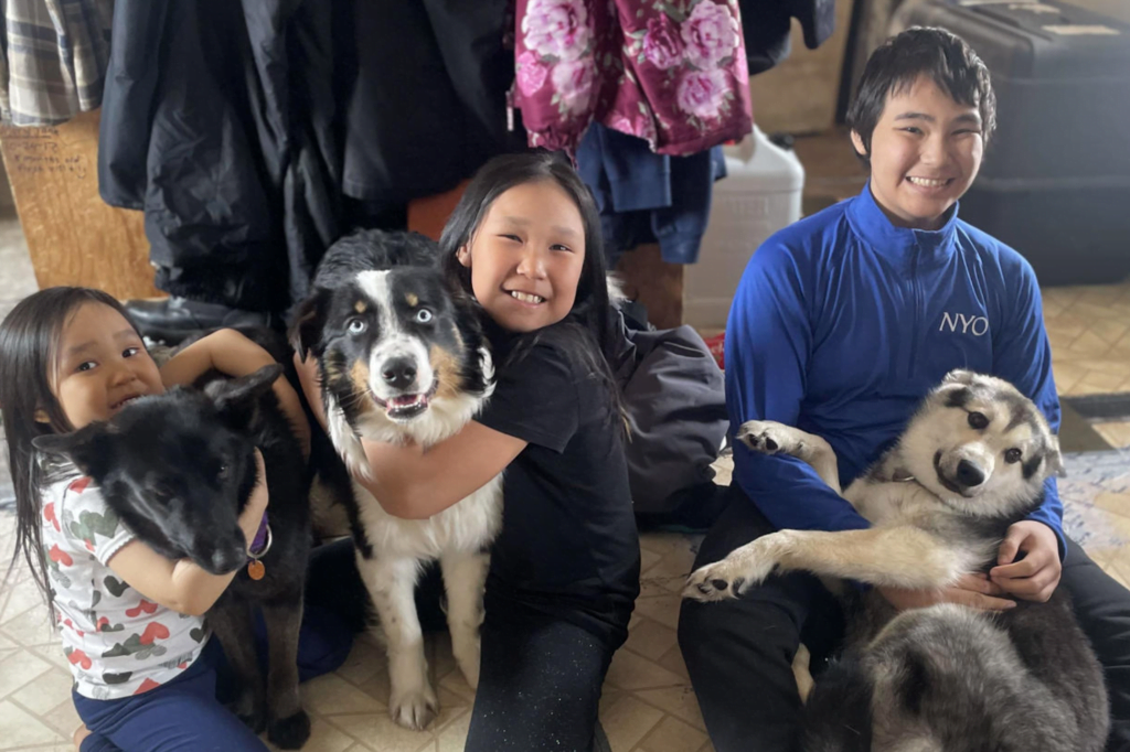 Nanuq in the middle with his humans around him